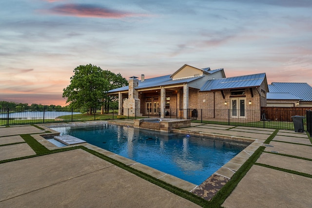 1100 Triple Crown Ct, Bartonville, TX 76226 - pool at dusk with a patio area, a pool with connected hot tub, and french doors