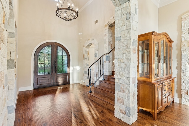 1100 Triple Crown Ct, Bartonville, TX 76226 - entrance foyer featuring arched walkways, french doors, a chandelier, ornamental molding, and wood finished floors