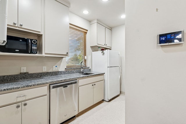 1100 Triple Crown Ct, Bartonville, TX 76226 - kitchen featuring stainless steel dishwasher, a sink, black microwave, freestanding refrigerator, and white cabinets