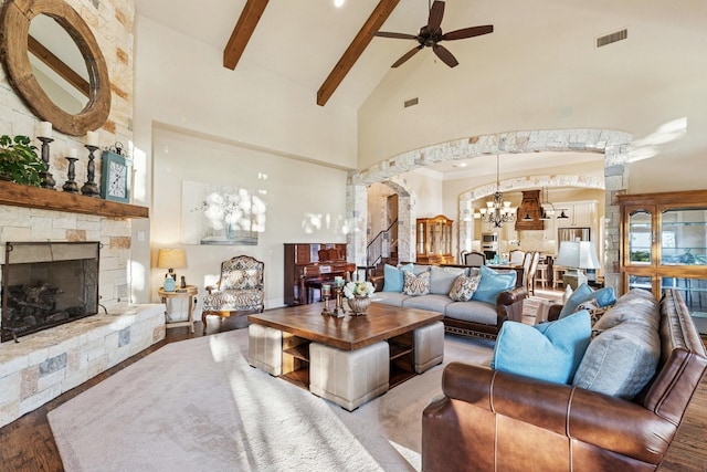 1100 Triple Crown Ct, Bartonville, TX 76226 - living area featuring high vaulted ceiling, a ceiling fan, a chandelier, a stone fireplace, and beamed ceiling