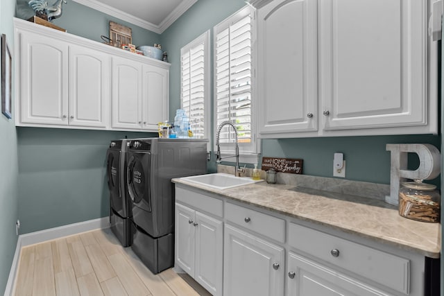 1809 Summit Ct, Keller, TX 76262 - washroom with washer and clothes dryer, cabinet space, crown molding, baseboards, and light wood-style flooring