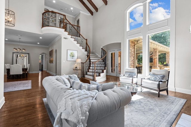 1809 Summit Ct, Keller, TX 76262 - living room with arched walkways, a chandelier, a high ceiling, stairway, and baseboards