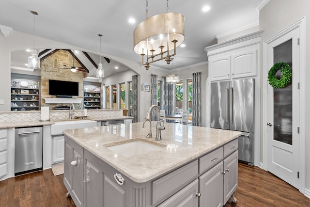 1809 Summit Ct, Keller, TX 76262 - kitchen with stainless steel appliances, a sink, a ceiling fan, open floor plan, and ornamental molding