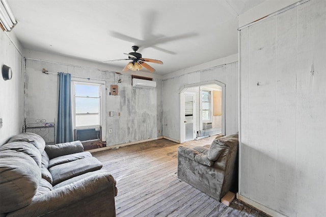 402 S Watson St, Alvarado, TX 76009 - living area with a wall mounted AC, ceiling fan, wood finished floors, and arched walkways