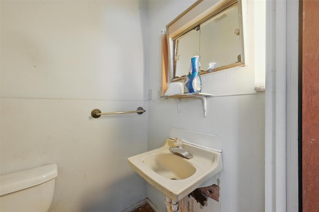 402 S Watson St, Alvarado, TX 76009 - half bathroom featuring toilet and a sink