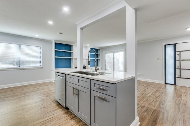 2638 Custer Pkwy Unit B, Richardson, TX 75080 - kitchen with gray cabinets, a sink, stainless steel dishwasher, light wood-type flooring, and baseboards