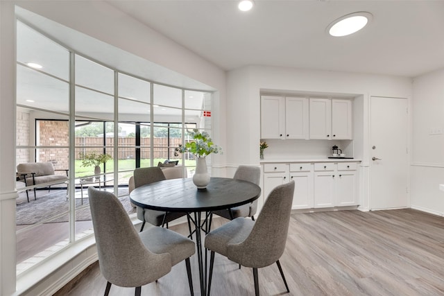 dining area featuring light wood-style flooring and recessed lighting