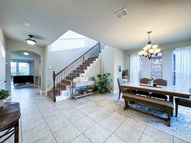 4237 Old Timber Ln, Fort Worth, TX 76036 - dining area with stairway, a chandelier, light tile patterned floors, arched walkways, and healthy amount of natural light