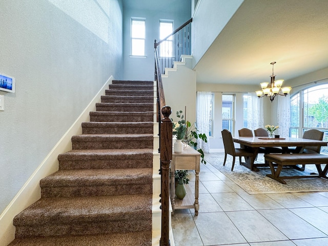 4237 Old Timber Ln, Fort Worth, TX 76036 - stairs featuring a chandelier, healthy amount of natural light, a textured wall, and tile patterned flooring
