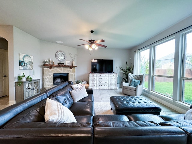 4237 Old Timber Ln, Fort Worth, TX 76036 - tiled living area with ceiling fan, a stone fireplace, and baseboards