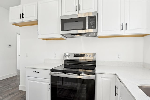 3613 Durango Trl, Granbury, TX 76048 - kitchen featuring stainless steel appliances, wood finished floors, light countertops, and white cabinets