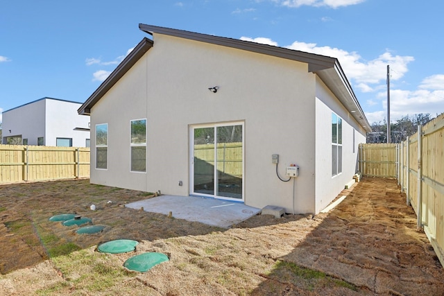 3613 Durango Trl, Granbury, TX 76048 - rear view of house with stucco siding, a fenced backyard, and a patio