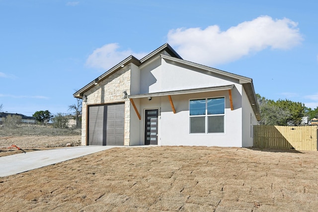 3613 Durango Trl, Granbury, TX 76048 - view of front of property featuring stucco siding, driveway, a garage, fence, and stone siding