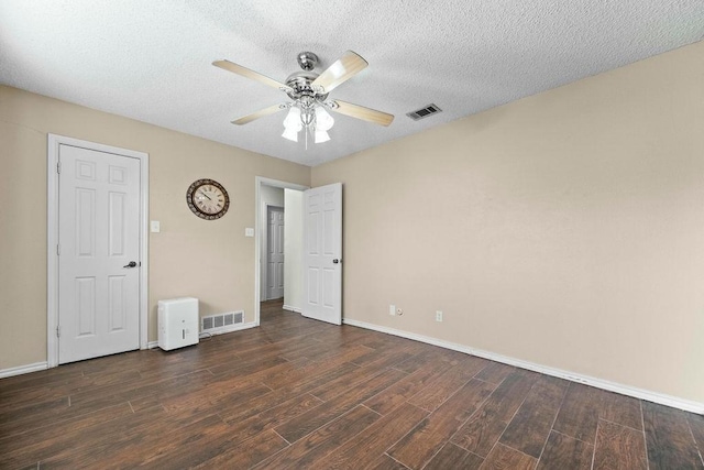 6939 Calender Rd, Arlington, TX 76001 - unfurnished bedroom featuring wood finished floors, baseboards, a ceiling fan, and a textured ceiling