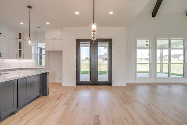 138 Buddy Ct, Millsap, TX 76066 - kitchen with french doors, white cabinets, decorative backsplash, baseboards, and light wood finished floors