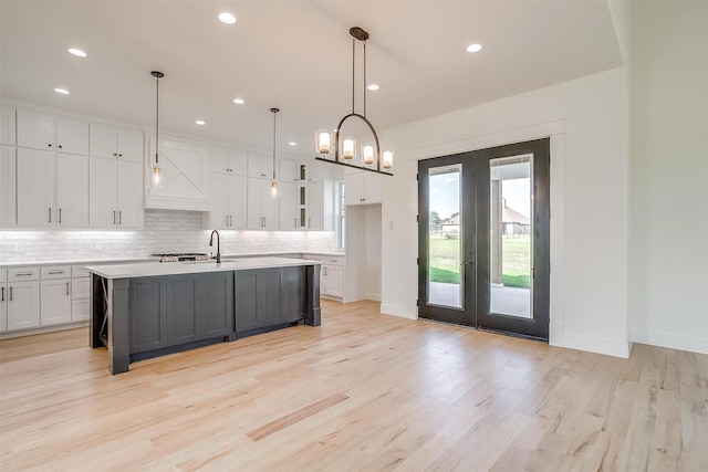 138 Buddy Ct, Millsap, TX 76066 - kitchen with french doors, white cabinets, light countertops, tasteful backsplash, and recessed lighting
