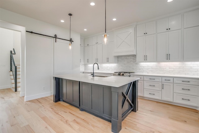 138 Buddy Ct, Millsap, TX 76066 - kitchen with a barn door, a sink, white cabinetry, tasteful backsplash, and recessed lighting