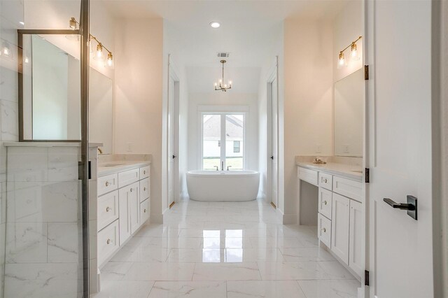138 Buddy Ct, Millsap, TX 76066 - bathroom with marble tiled floors, a freestanding bath, a chandelier, baseboards, and two vanities