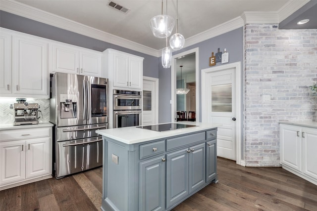 5060 Loma Alta Dr, Frisco, TX 75034 - kitchen featuring appliances with stainless steel finishes, white cabinetry, dark wood-style flooring, and ornamental molding