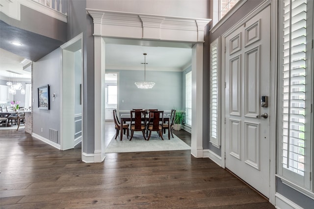 5060 Loma Alta Dr, Frisco, TX 75034 - foyer entrance featuring a chandelier, dark wood-style flooring, ornamental molding, and baseboards