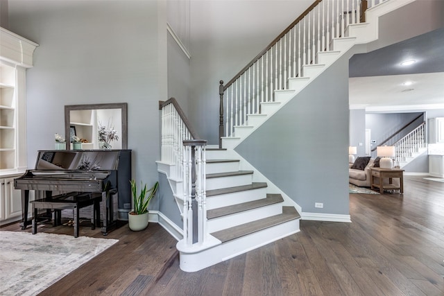5060 Loma Alta Dr, Frisco, TX 75034 - stairway featuring a towering ceiling, wood finished floors, and baseboards