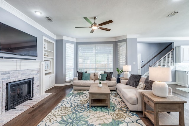 5060 Loma Alta Dr, Frisco, TX 75034 - living room featuring ceiling fan, stairway, wood finished floors, ornamental molding, and a brick fireplace