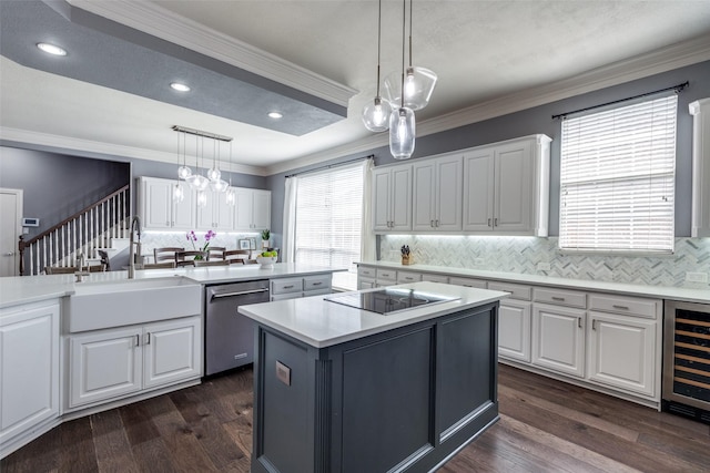 5060 Loma Alta Dr, Frisco, TX 75034 - kitchen with stainless steel dishwasher, beverage cooler, a kitchen island, white cabinets, and crown molding