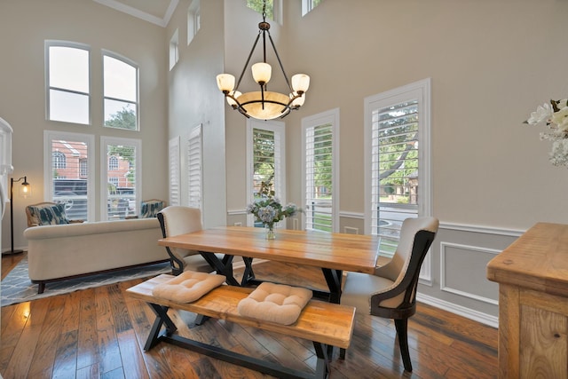 1123 Shadetree Ln, Allen, TX 75013 - dining space featuring a chandelier, plenty of natural light, dark wood-style flooring, a high ceiling, and crown molding