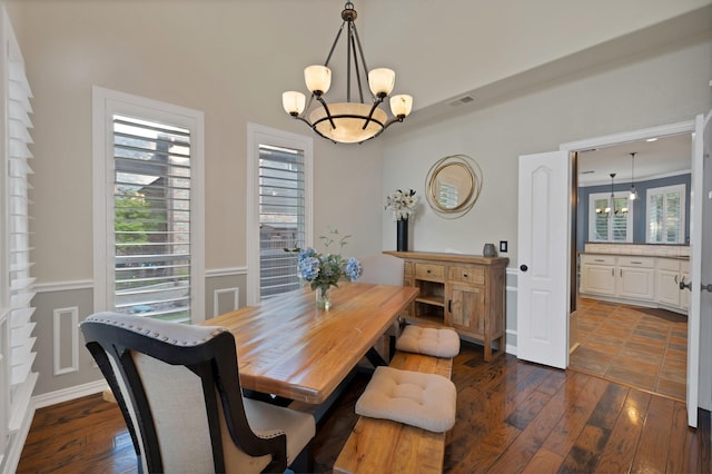 1123 Shadetree Ln, Allen, TX 75013 - dining area featuring a chandelier, dark wood-style floors, healthy amount of natural light, and a wainscoted wall