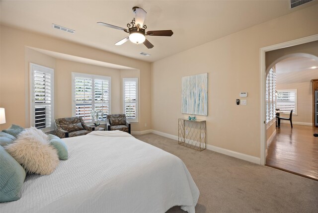 864 Gaited Trl, Frisco, TX 75036 - bedroom featuring arched walkways, baseboards, light colored carpet, and a ceiling fan