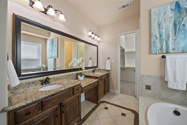 864 Gaited Trl, Frisco, TX 75036 - full bathroom with tile patterned flooring, double vanity, a bath, a walk in closet, and baseboards