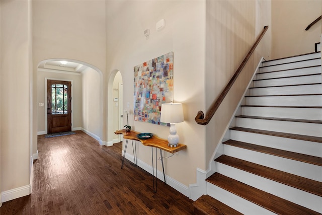 864 Gaited Trl, Frisco, TX 75036 - foyer featuring arched walkways, wood finished floors, stairway, a high ceiling, and baseboards