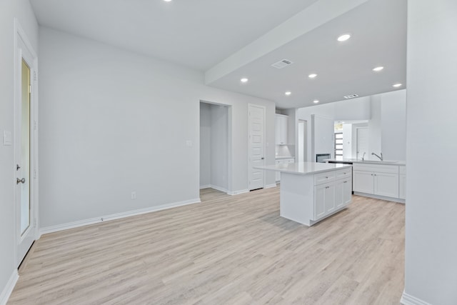 4342 Hudson St, Fate, TX 75087 - kitchen with white cabinets, light wood-type flooring, a sink, recessed lighting, and baseboards
