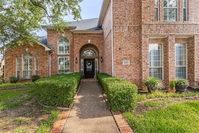 2420 Norwich Dr, Carrollton, TX 75006 - property entrance with brick siding and roof with shingles