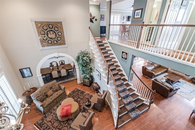 2420 Norwich Dr, Carrollton, TX 75006 - stairway with a high ceiling, wood finished floors, arched walkways, and ceiling fan
