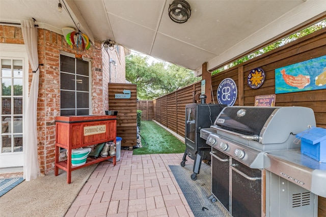 2420 Norwich Dr, Carrollton, TX 75006 - view of patio featuring a grill and fence