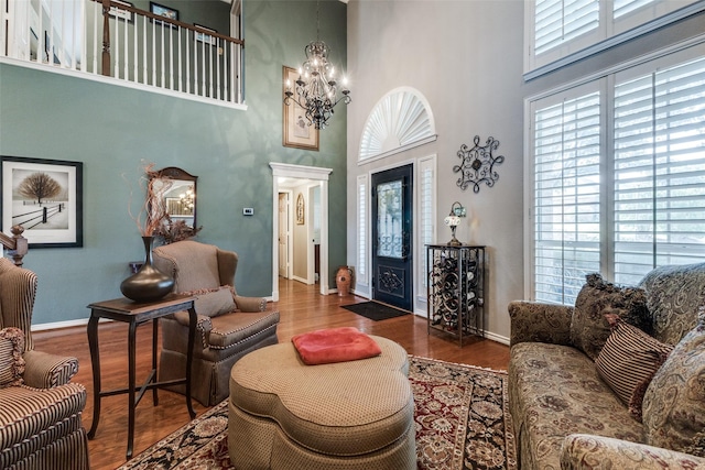 2420 Norwich Dr, Carrollton, TX 75006 - living room featuring a chandelier, a high ceiling, baseboards, and wood finished floors