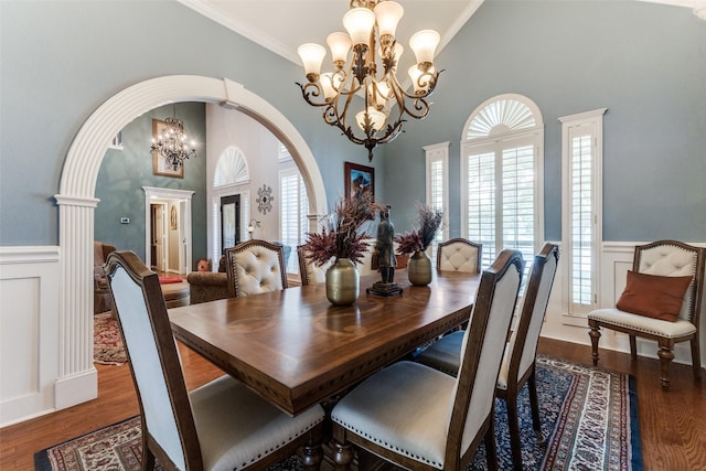 2420 Norwich Dr, Carrollton, TX 75006 - dining space with a chandelier, arched walkways, wainscoting, wood finished floors, and ornamental molding