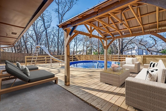 7013 Post Oak Dr, North Richland Hills, TX 76182 - view of swimming pool with a water slide, a fenced backyard, a deck, and an outdoor living space
