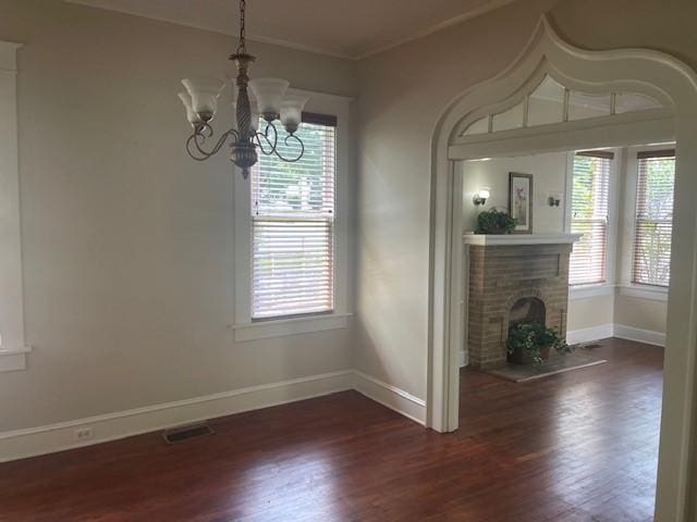 unfurnished dining area featuring healthy amount of natural light, wood finished floors, and ornamental molding