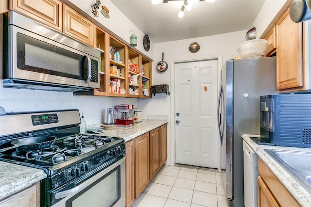 6900 Yorkston St, Watauga, TX 76148 - kitchen featuring appliances with stainless steel finishes, light tile patterned floors, a sink, open shelves, and light stone countertops