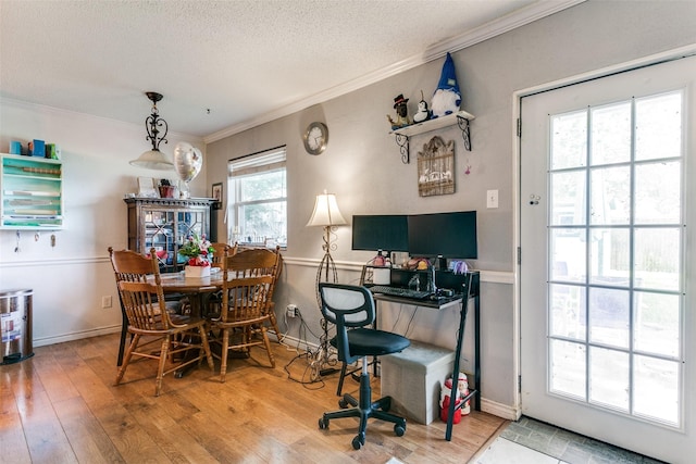 6900 Yorkston St, Watauga, TX 76148 - dining space featuring crown molding, hardwood / wood-style floors, a textured ceiling, and baseboards