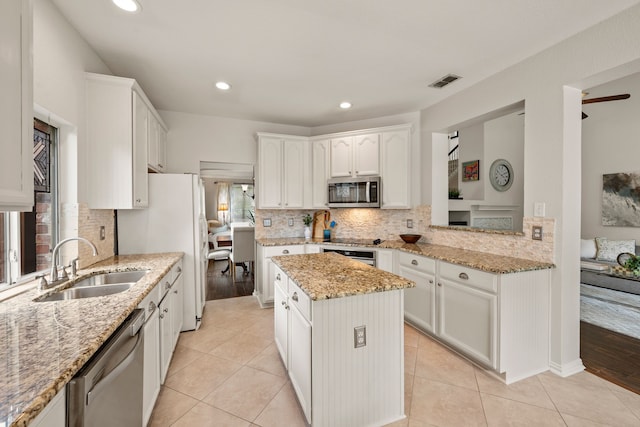 521 Austin Oaks Dr, Grapevine, TX 76051 - kitchen featuring appliances with stainless steel finishes, a sink, backsplash, white cabinets, and recessed lighting