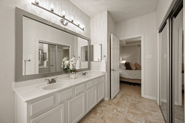 521 Austin Oaks Dr, Grapevine, TX 76051 - ensuite bathroom featuring double vanity and baseboards