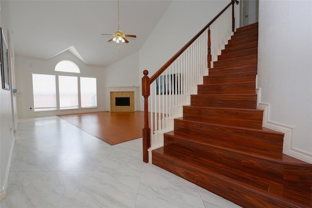 1104 Ruby St, Plano, TX 75094 - stairs featuring a fireplace, ceiling fan, high vaulted ceiling, and marble finish floors