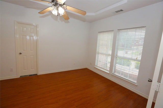 1104 Ruby St, Plano, TX 75094 - unfurnished room with wood finished floors, a ceiling fan, baseboards, and a tray ceiling