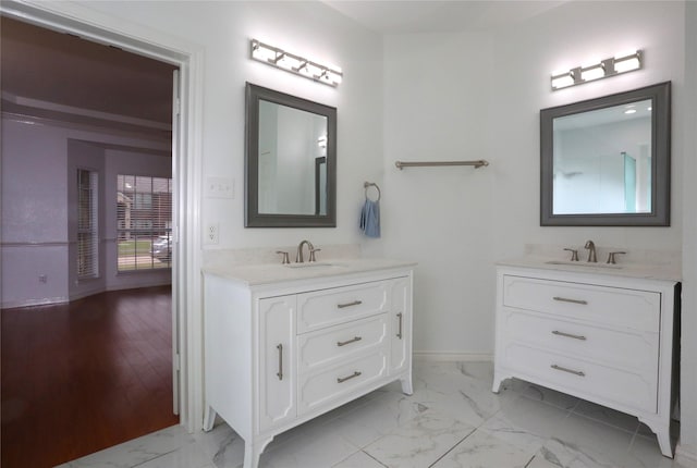 1104 Ruby St, Plano, TX 75094 - bathroom with two vanities, baseboards, and marble look tile flooring