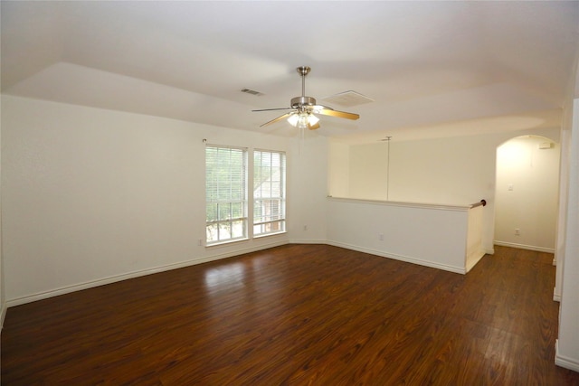 1104 Ruby St, Plano, TX 75094 - unfurnished room featuring dark wood-style flooring, arched walkways, a ceiling fan, and baseboards