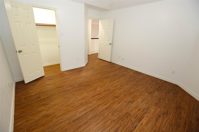 1104 Ruby St, Plano, TX 75094 - unfurnished bedroom with baseboards, wood finished floors, a walk in closet, and a closet