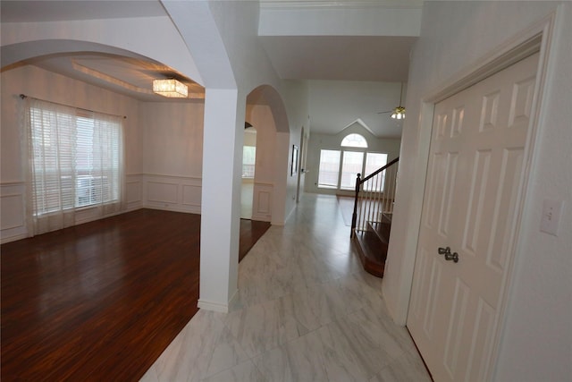1104 Ruby St, Plano, TX 75094 - hallway with arched walkways, a decorative wall, wainscoting, and wood finished floors